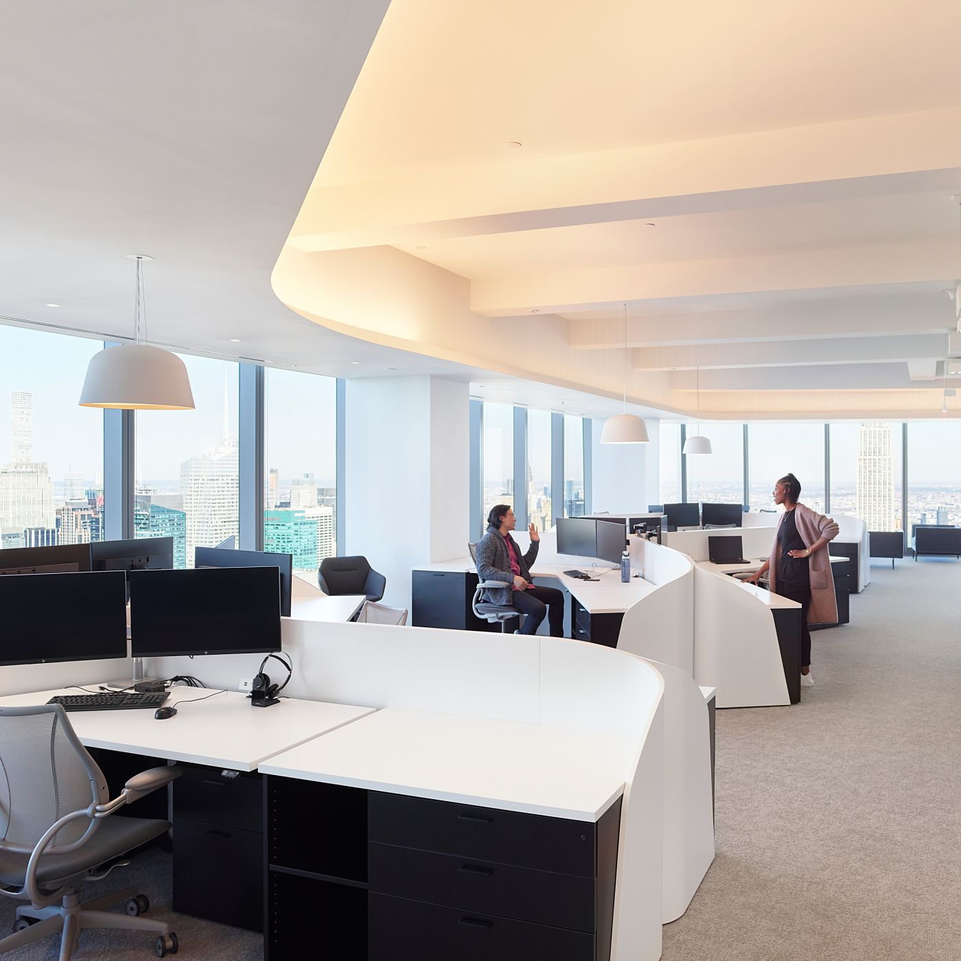 Custom open office stations maximize the spaces spectacular views and enhance the architectural details.